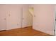 Bright bedroom with light hardwood floors and a standard door leading to other rooms at 14621 Waterside Dr, Charlotte, NC 28278