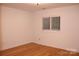 Well-lit bedroom featuring hardwood floors and a window with natural light at 14621 Waterside Dr, Charlotte, NC 28278