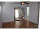 Bright bedroom featuring hardwood floors, a ceiling fan, and sliding glass doors to an outdoor balcony at 14621 Waterside Dr, Charlotte, NC 28278