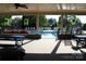 Inviting community pool with lounge seating and shaded picnic area surrounded by lush landscaping at 14621 Waterside Dr, Charlotte, NC 28278