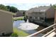 Exterior community view highlighting a building overlooking a pond and a fountain, showcasing the serene setting at 14621 Waterside Dr, Charlotte, NC 28278