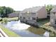 Exterior community view highlighting a building overlooking a pond and a fountain, showcasing the serene setting at 14621 Waterside Dr, Charlotte, NC 28278