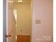 Hallway with hardwood floors and neutral-colored walls leading to other rooms at 14621 Waterside Dr, Charlotte, NC 28278