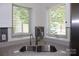 Close-up of kitchen sink area featuring stainless steel sink, brass faucet, and window with blinds at 14621 Waterside Dr, Charlotte, NC 28278