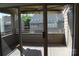 View of a private patio, accessed through sliding glass doors, with wood flooring and a building in the background at 14621 Waterside Dr, Charlotte, NC 28278