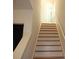 Bright staircase leading to the upper level with wooden steps and white risers at 14621 Waterside Dr, Charlotte, NC 28278