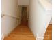 View of the home's wooden staircase with white walls and trim leading to the next level at 14621 Waterside Dr, Charlotte, NC 28278