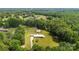 Expansive aerial view of a brick home on a large, wooded lot in a serene neighborhood at 1512 Mount Ulla Hwy, Mooresville, NC 28115