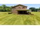 Backyard with garage and covered patio in the distance at 1512 Mount Ulla Hwy, Mooresville, NC 28115