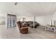 Relaxing basement living area features an oversized sofa, recliner, and vinyl floors at 1512 Mount Ulla Hwy, Mooresville, NC 28115