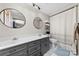 Bright bathroom with double vanity sinks, round mirrors, and tiled floor at 1512 Mount Ulla Hwy, Mooresville, NC 28115