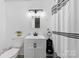 Modern bathroom with a vanity, mirror, black fixtures, and a black and white shower curtain at 1512 Mount Ulla Hwy, Mooresville, NC 28115