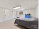 Cozy bedroom with a window, closet, and gray plank floors at 1512 Mount Ulla Hwy, Mooresville, NC 28115