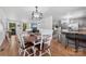 Inviting dining area next to the kitchen with hardwood floors and stylish lighting at 1512 Mount Ulla Hwy, Mooresville, NC 28115
