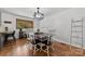 Bright dining area features a dark wood table, white chairs, and a modern pendant light fixture at 1512 Mount Ulla Hwy, Mooresville, NC 28115