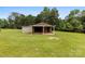 Exterior shot of a garage with a covered patio and lush green yard at 1512 Mount Ulla Hwy, Mooresville, NC 28115