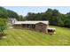 Beautiful brick home with a metal roof, covered carport, and a well-manicured lawn at 1512 Mount Ulla Hwy, Mooresville, NC 28115