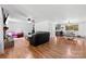 Bright living room with fireplace, hardwood floors, and open layout to dining area and kitchen at 1512 Mount Ulla Hwy, Mooresville, NC 28115