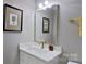 Stylish bathroom with a white vanity, gold-tone faucet, framed mirror, and neutral decor at 15215 Arleta Cir, Charlotte, NC 28277