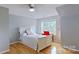 Bright bedroom with hardwood floors, large window, and a neutral color scheme at 15215 Arleta Cir, Charlotte, NC 28277