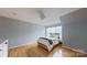 Light-filled bedroom featuring hardwood floors and ample natural light at 15215 Arleta Cir, Charlotte, NC 28277