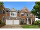Charming brick home featuring a two-car garage, manicured lawn, and traditional architectural details at 15215 Arleta Cir, Charlotte, NC 28277