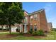 Well-maintained brick home showcasing a lush front yard and classic design elements at 15215 Arleta Cir, Charlotte, NC 28277
