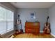 Cozy living room with natural light, hardwood floors, and musical instruments at 15215 Arleta Cir, Charlotte, NC 28277