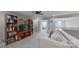 Bright loft area with built-in bookshelves and a comfortable seating area at 15215 Arleta Cir, Charlotte, NC 28277