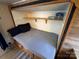 RV bedroom featuring a fold-down Murphy bed and built-in window storage at 164 Dogwood Cir, New London, NC 28127