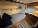 RV bedroom with a folding Murphy bed, storage, and a built-in window desk at 164 Dogwood Cir, New London, NC 28127