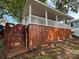 Charming exterior view showcasing a covered porch with white railings and wood-finished siding and stairs at 164 Dogwood Cir, New London, NC 28127
