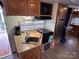RV kitchen with a sink, microwave, stove, and refrigerator, ready for meal preparation on the go at 164 Dogwood Cir, New London, NC 28127