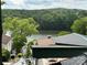 Scenic lake view with surrounding lush greenery and a glimpse of the rooflines of lakeside homes at 164 Dogwood Cir, New London, NC 28127