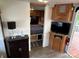 Functional RV living space with storage, a TV, and doorway to the bedroom for convenient living at 164 Dogwood Cir, New London, NC 28127