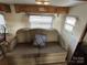 Comfortable RV living room with a cozy sofa and natural light filtering through the window blinds at 164 Dogwood Cir, New London, NC 28127