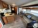 RV interior showcasing living area with wood-look floors and kitchen at 164 Dogwood Cir, New London, NC 28127