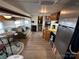 Cozy RV interior with wood floors, dinette set, sofa, and efficient kitchen at 164 Dogwood Cir, New London, NC 28127
