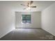 Bedroom with ceiling fan, a window, and neutral walls and carpet at 177 Jacobs Woods Cir, Troutman, NC 28166