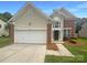 Charming home featuring a two-car garage, manicured lawn and brick and siding accent at 177 Jacobs Woods Cir, Troutman, NC 28166