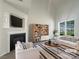 Bright living room featuring a fireplace, large windows, and modern furnishings at 177 Jacobs Woods Cir, Troutman, NC 28166