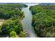 Scenic aerial view of lake surrounded by dense forest, dotted with docks and boats along its shores at 19143 Juanita Ln, Cornelius, NC 28031