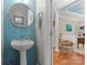 Stylish half bathroom with blue tile accents and a pedestal sink at 19143 Juanita Ln, Cornelius, NC 28031