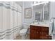 Bathroom with toilet, vanity, and shower with a curtain at 19143 Juanita Ln, Cornelius, NC 28031