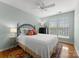 Bedroom with hardwood floors, natural light, ceiling fan, and stylish decor at 19143 Juanita Ln, Cornelius, NC 28031
