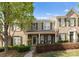 Charming brick townhome featuring a covered front porch and well-manicured landscaping at 19143 Juanita Ln, Cornelius, NC 28031