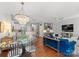 Open-concept living space with stylish lighting, a kitchen island, and a comfortable blue sofa at 19143 Juanita Ln, Cornelius, NC 28031