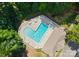 A heart-shaped community swimming pool with lounge chairs, a swimmer, and a building for residents to enjoy at 19143 Juanita Ln, Cornelius, NC 28031