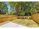 The backyard has new wood fencing, grass, and a small patio perfect for outdoor activities at 2006 St John St, Charlotte, NC 28216