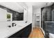 Modern bathroom features marble accents, dual sink vanity, and a glass enclosed shower at 2006 St John St, Charlotte, NC 28216